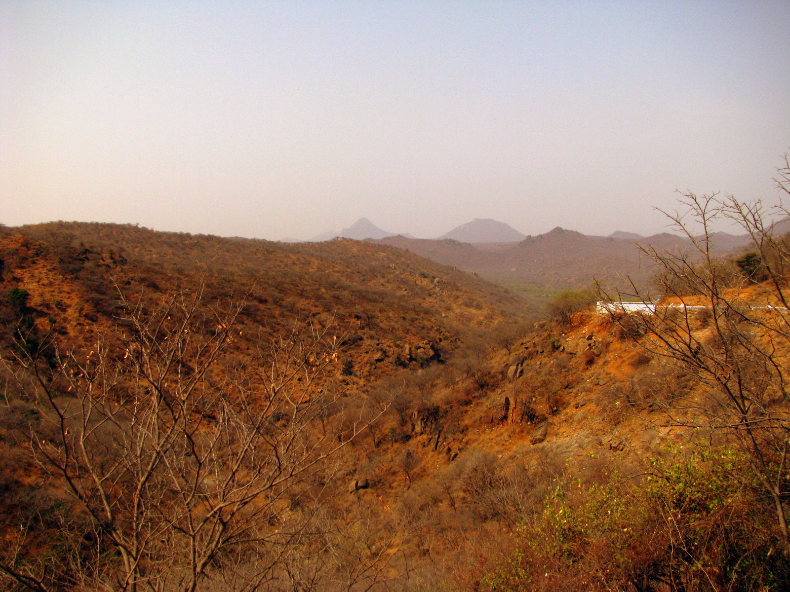 a small white structure sits atop a mountain