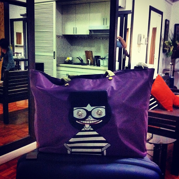 a tote bag with an angry looking face on it