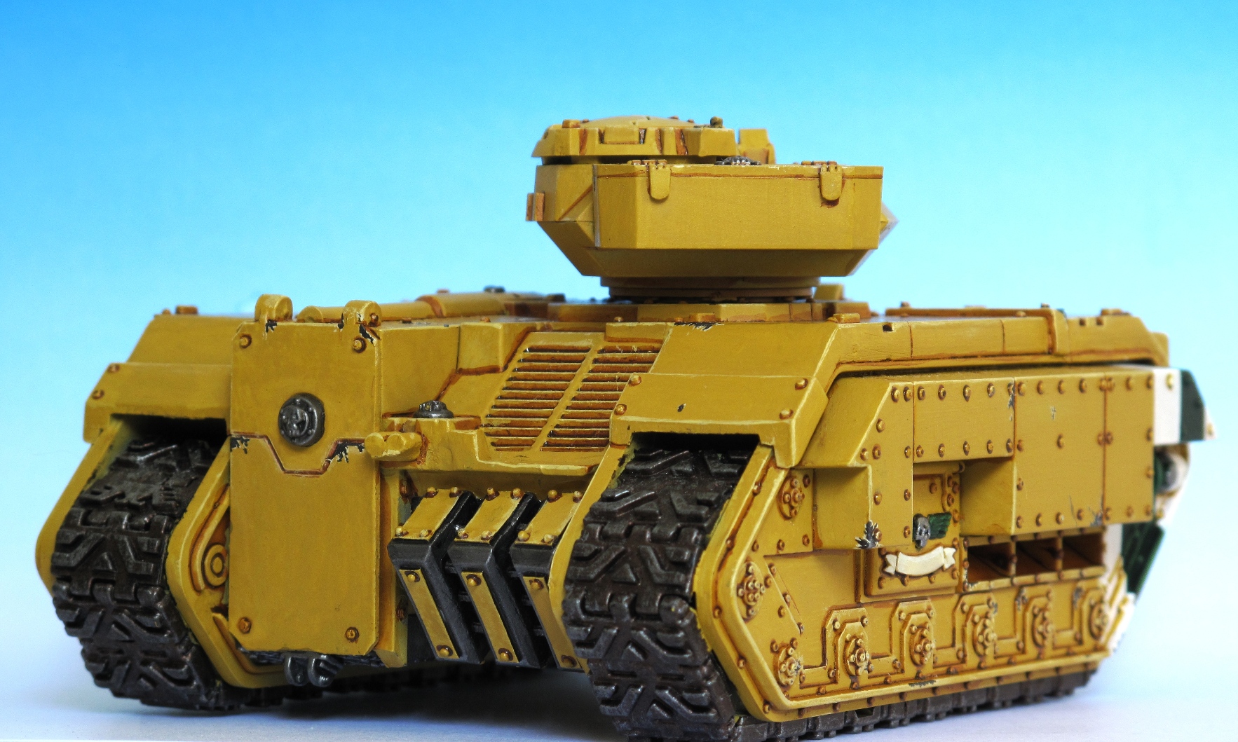 yellow painted toy tank with metal handles and treads