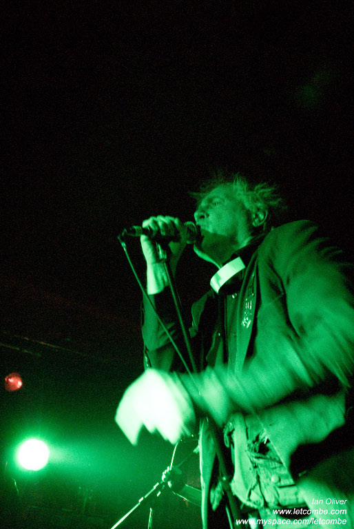 a man with a microphone performing on stage