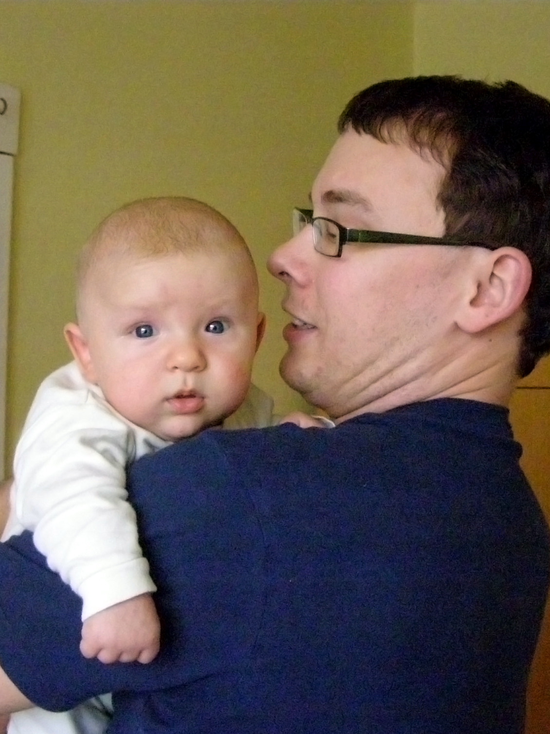 man holding a baby boy in his arms