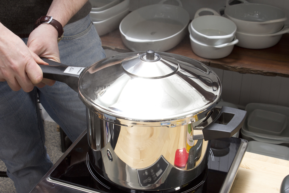 a man is cooking in his stove with a ladle