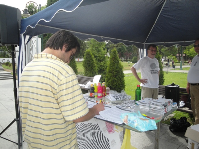 a man is selling food to others under a canopy