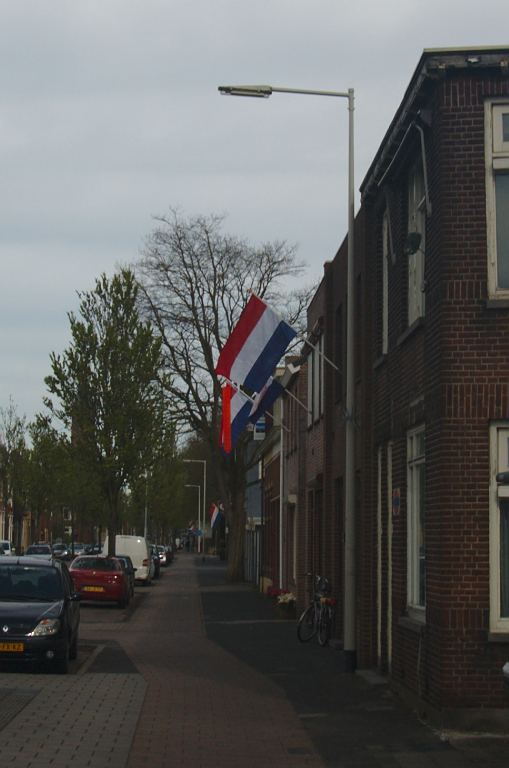 an open red, white and blue flag on a street corner