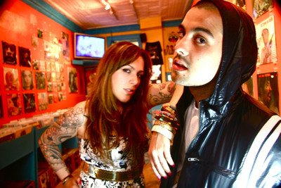 man and woman at a bar with tattoos on their arm