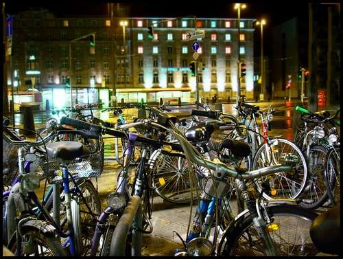 the bicycle racks are full of bicycles at night
