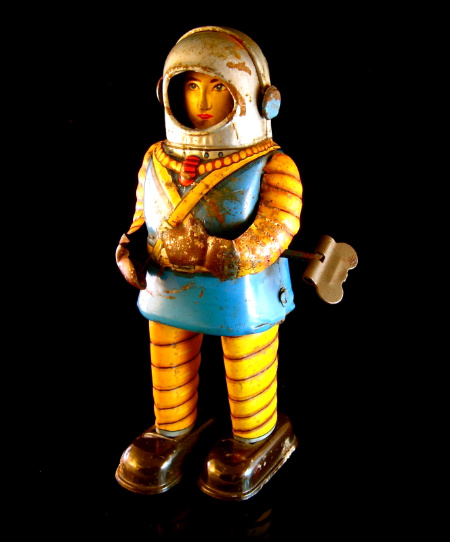 a figurine of an astronaut on a black background