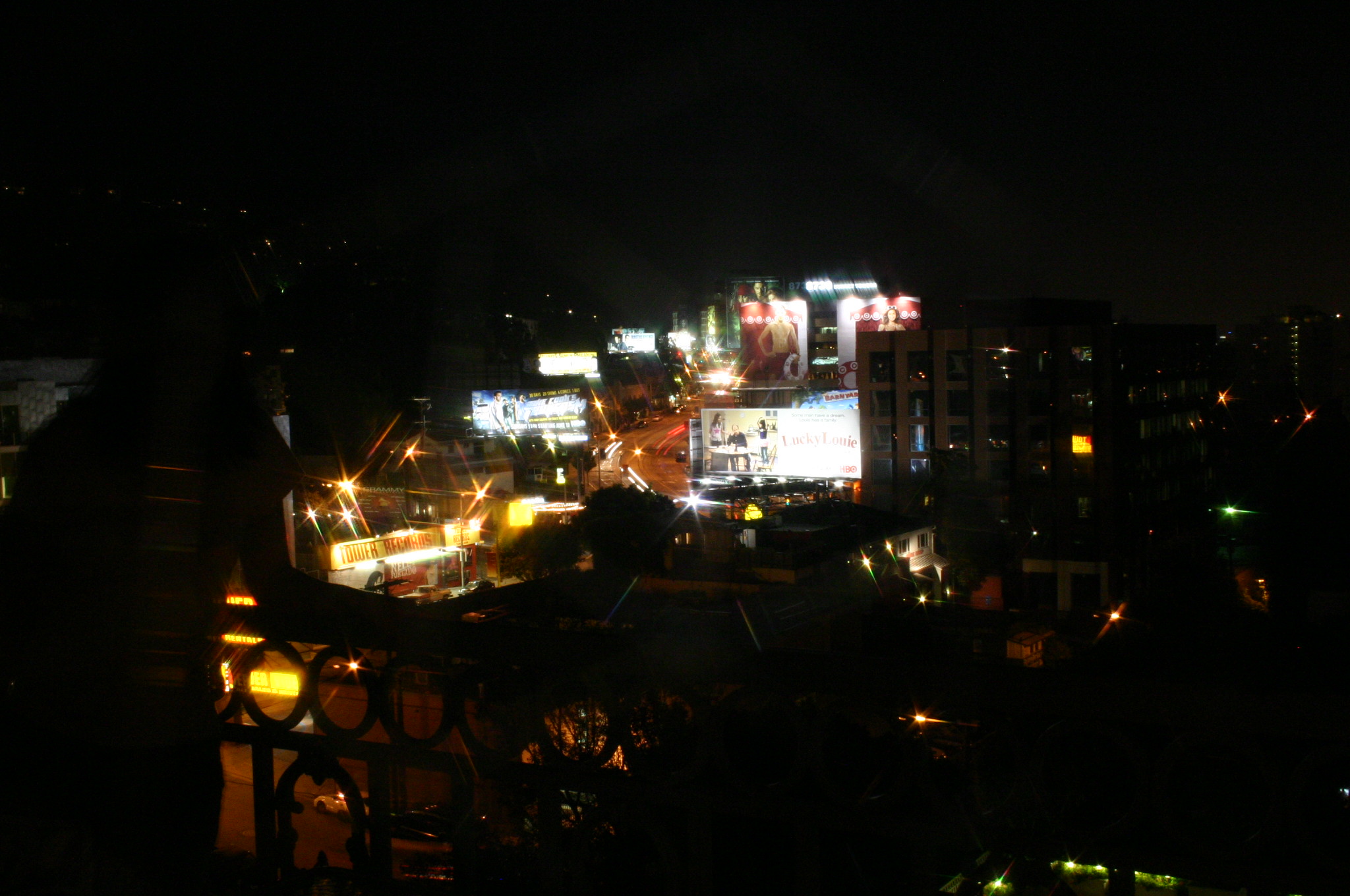 nighttime city buildings are brightly lit up in the dark