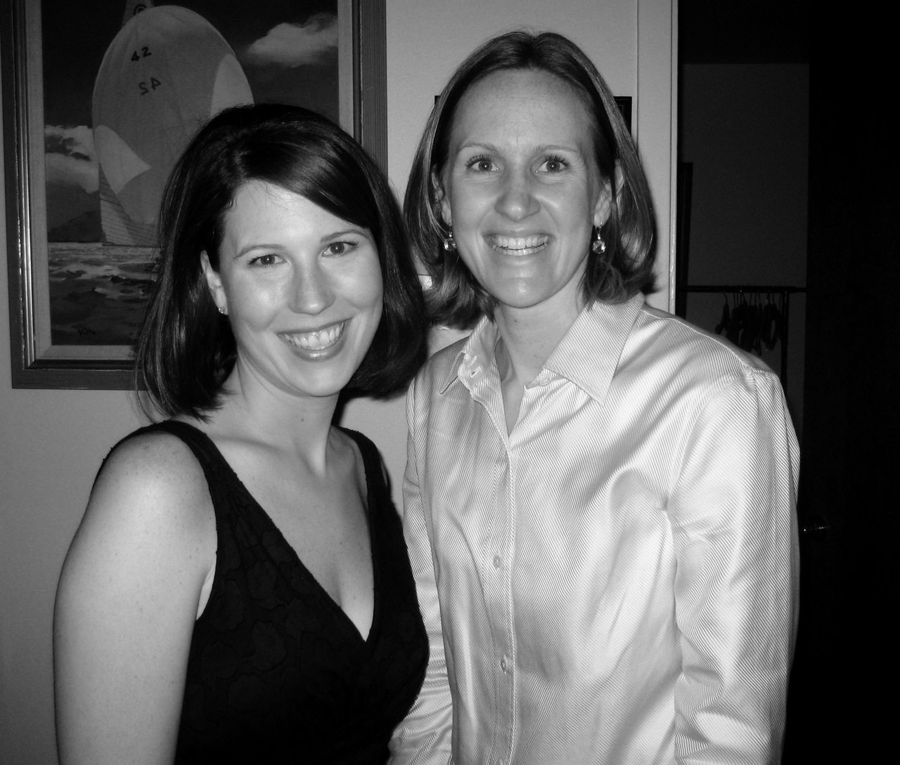 two women standing next to each other smiling for the camera
