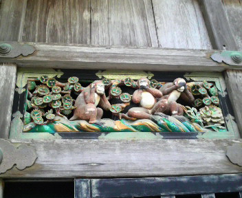 decorative art pieces mounted to a wooden building wall