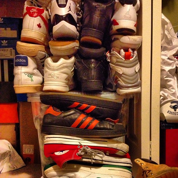 a rack with multiple shoes stacked high on it