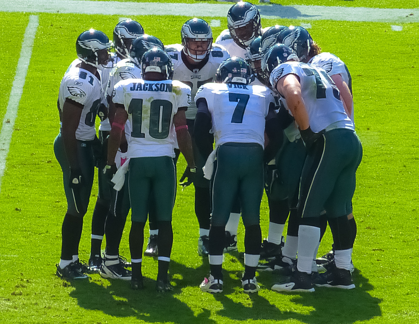 several football players huddled up for a huddle