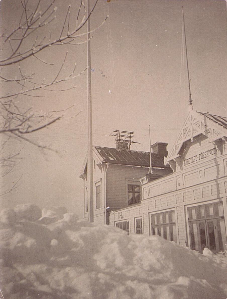 an old pograph of a building and some snow