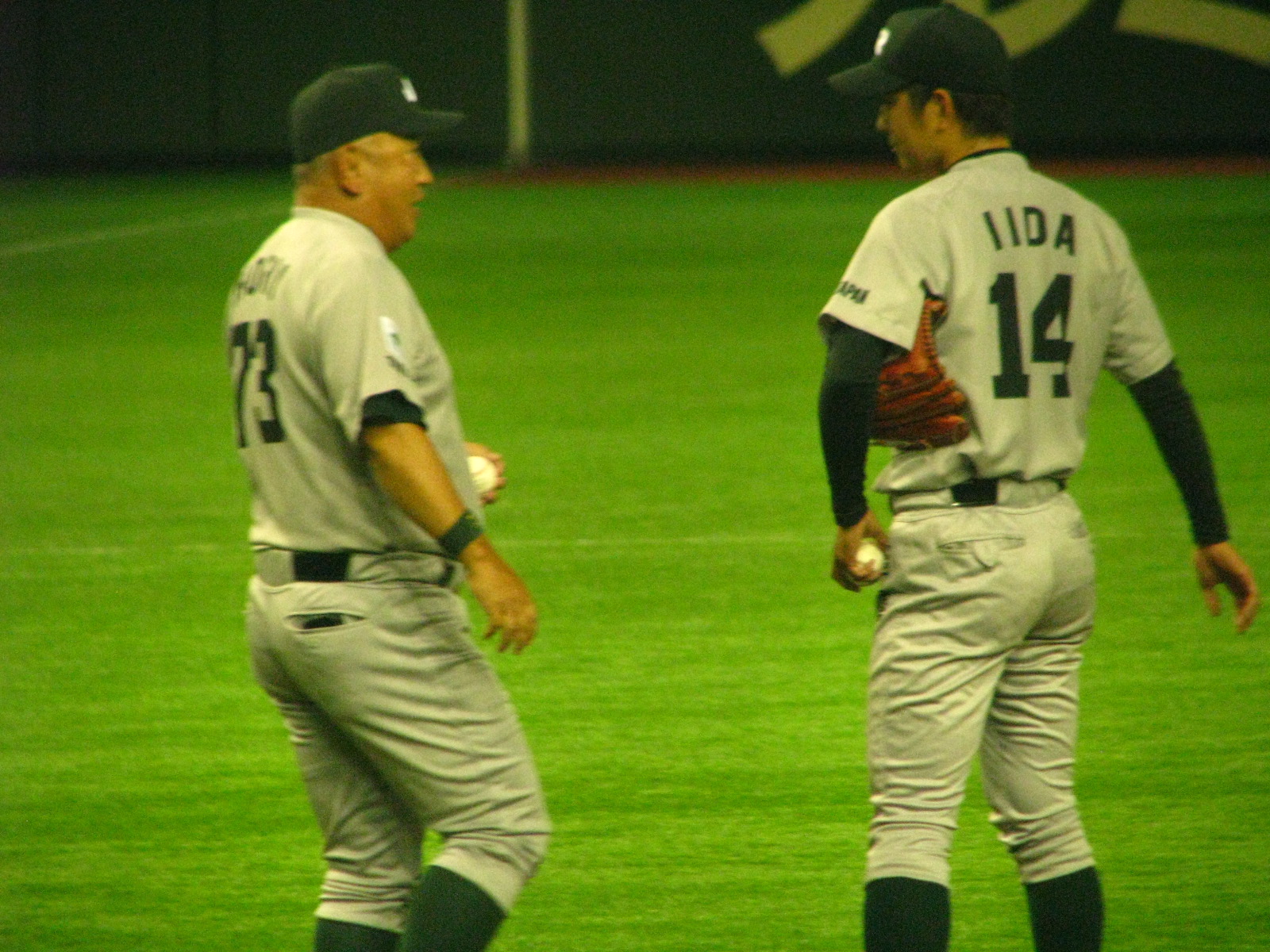 two baseball players talking on a field