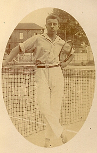 old po of young man in sailor costume holding tennis racket