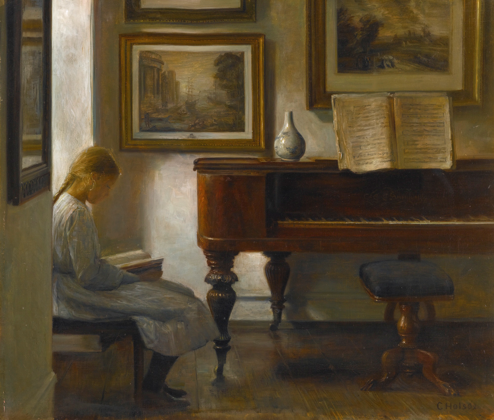 a woman sitting at a piano and reading