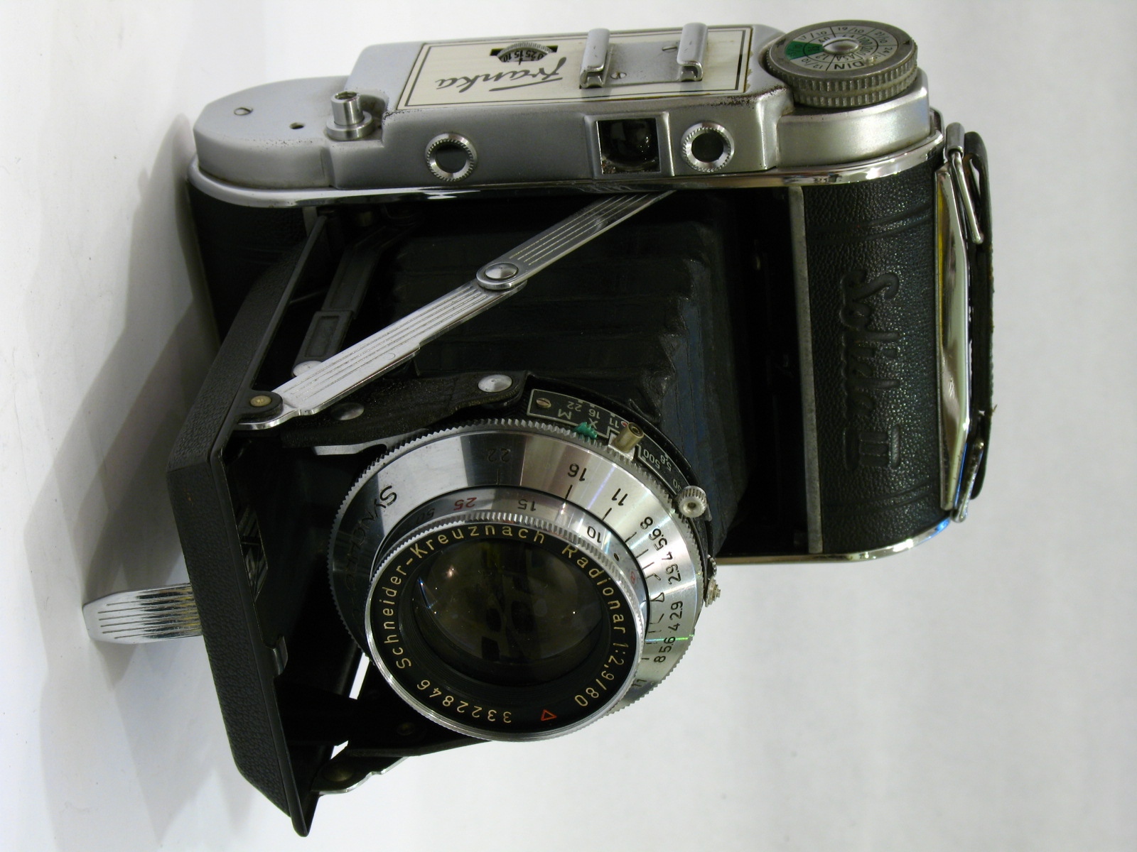 an old fashioned camera on a table next to a magnifying lens