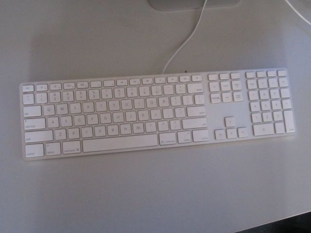 a keyboard sitting on a table next to a mouse