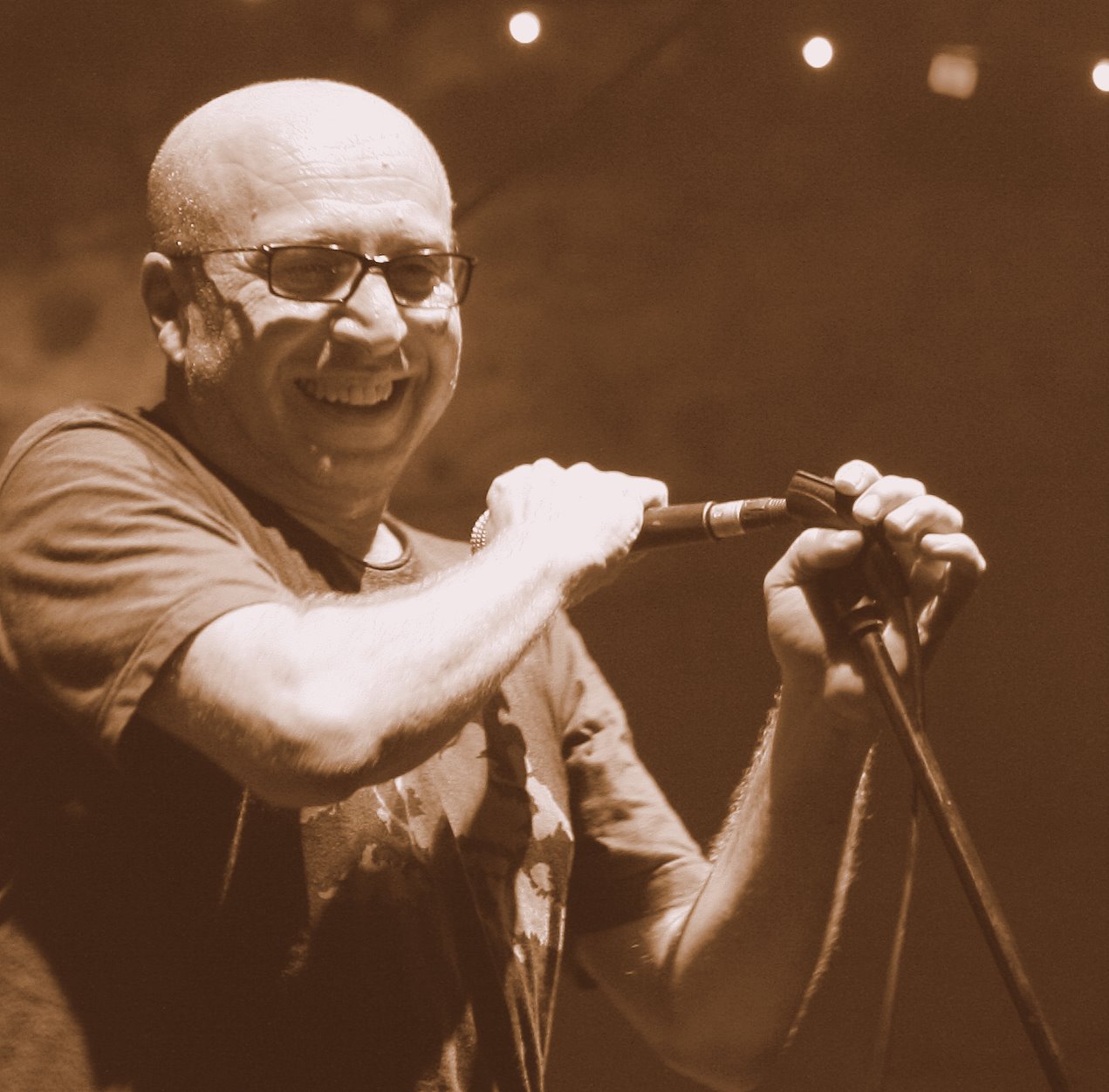 a man on stage with an microphone in his hand