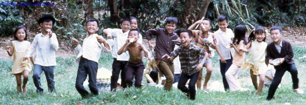 several young children and one boy posing for a group pograph