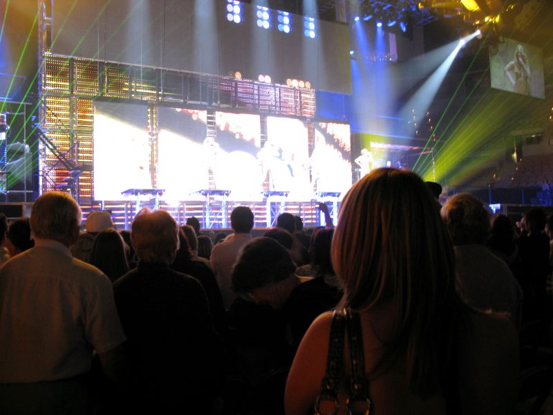 a large audience of people watching concert lights