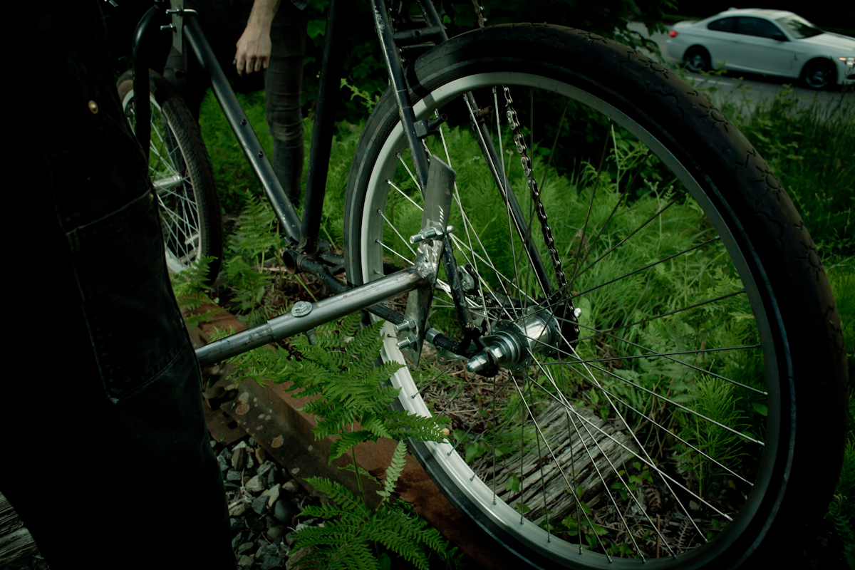 a person standing next to a bicycle in a field