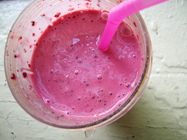 a pink smoothie with a pink straw stuck into it