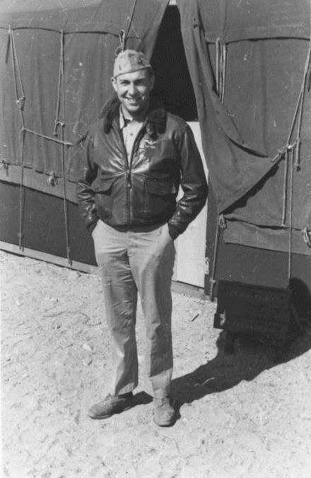 an old po of a man standing in front of a large airplane