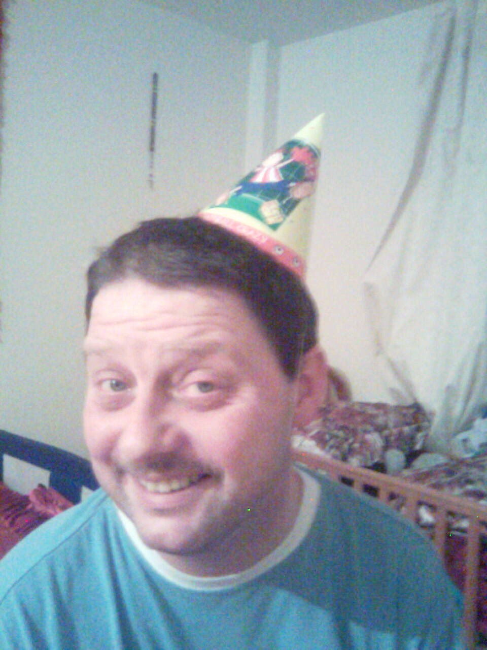a man with a party hat is staring ahead