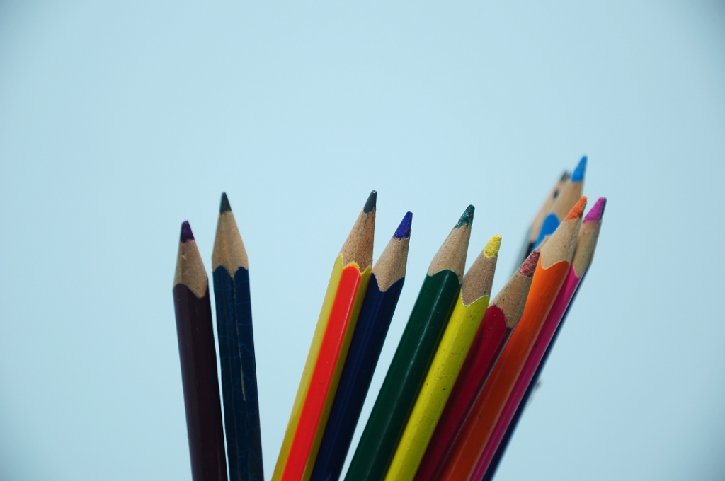 a close up of many colorful pencils
