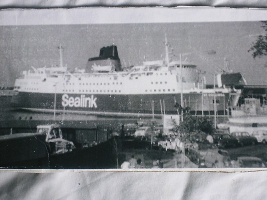 a large passenger ship docked with other ships