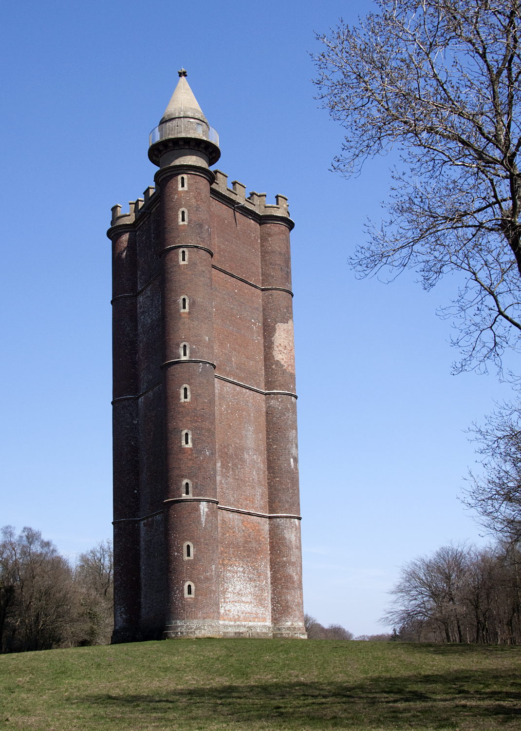 a tower is shown from the side while surrounded by trees