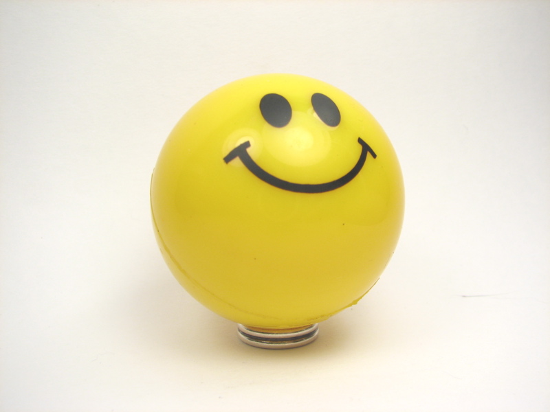 there is a yellow sphere with a happy face on it