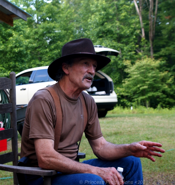 a man sitting on a bench in the grass