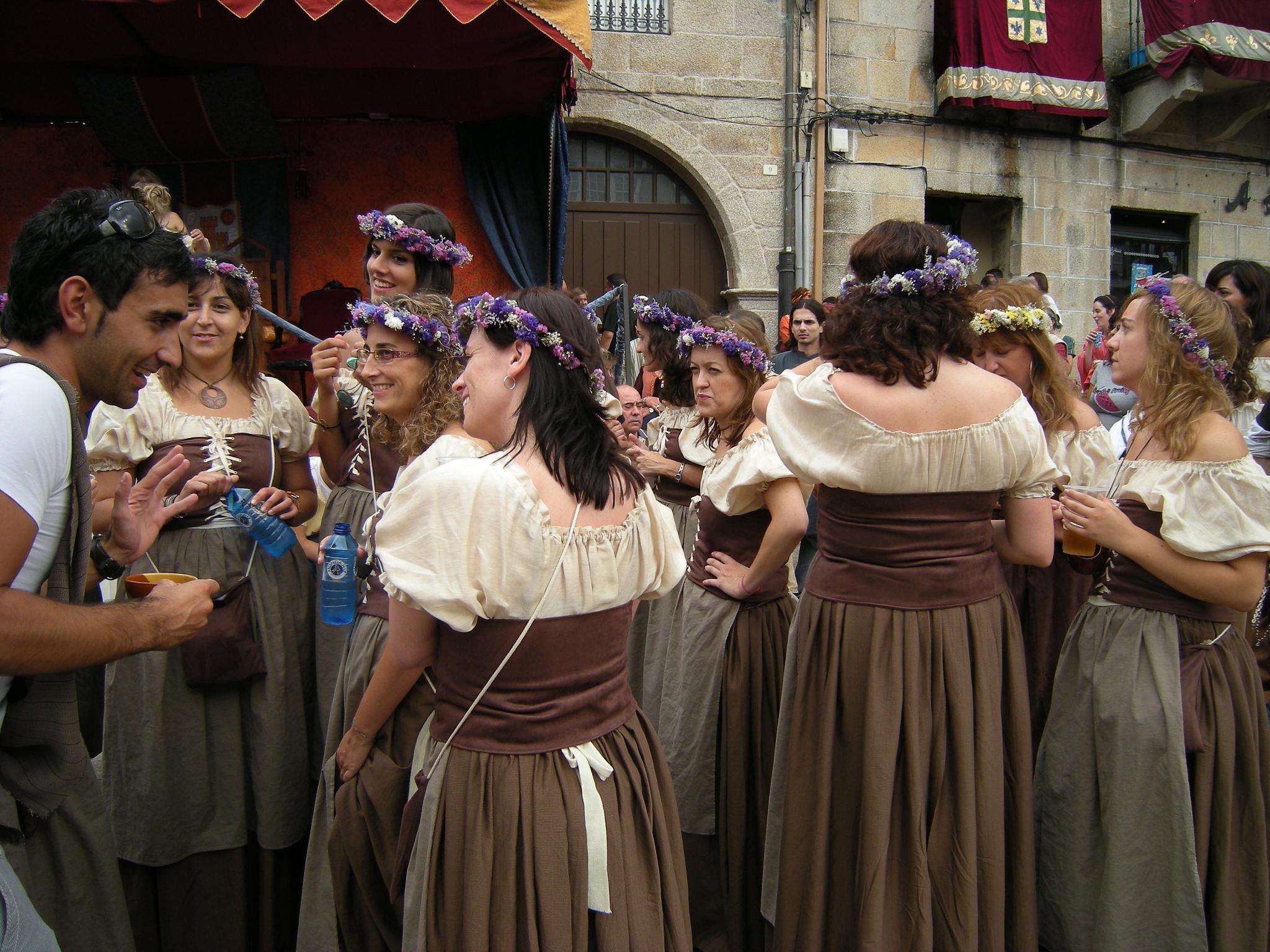 a group of people standing next to each other in front of a building