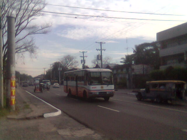 a city bus is traveling on the road