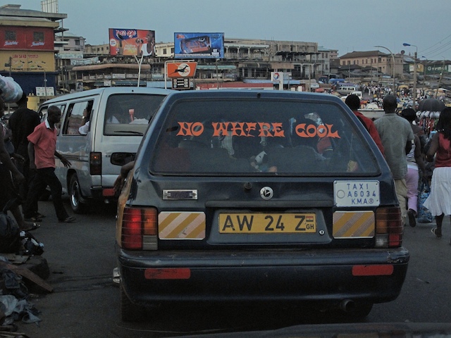 a car is traveling through an urban street