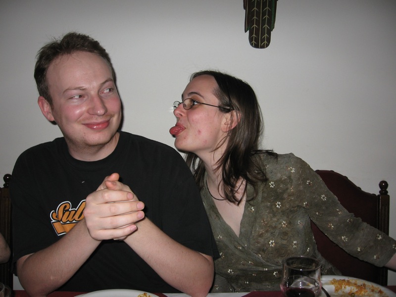 a man and a woman are eating at a dinner table