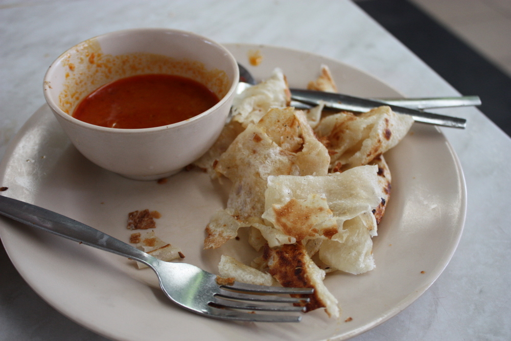 a plate filled with meat crepes and a cup of tomato soup