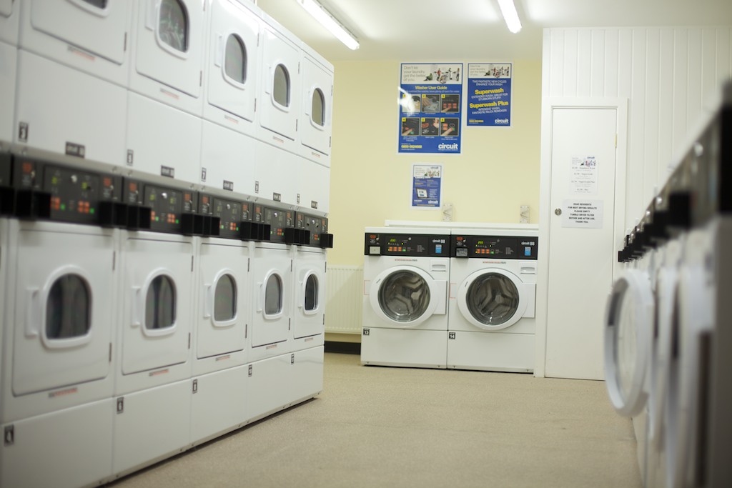 a large room with machines and washers inside