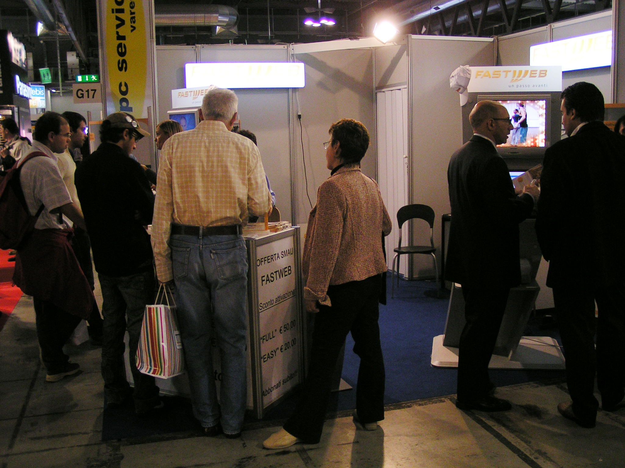 group of people waiting in line at indoor exhibit