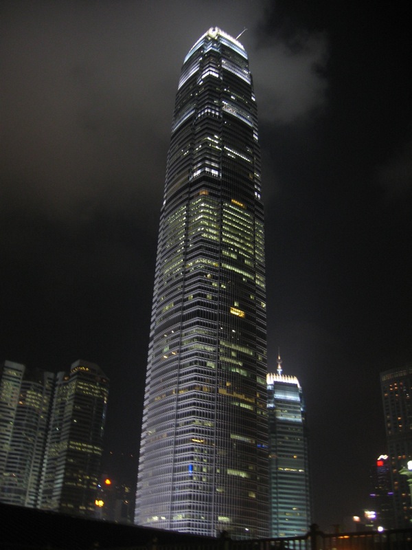 an illuminated skyscr with some clouds in the background