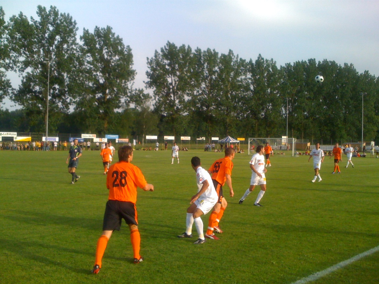 a group of boys playing soccer on a soccer field