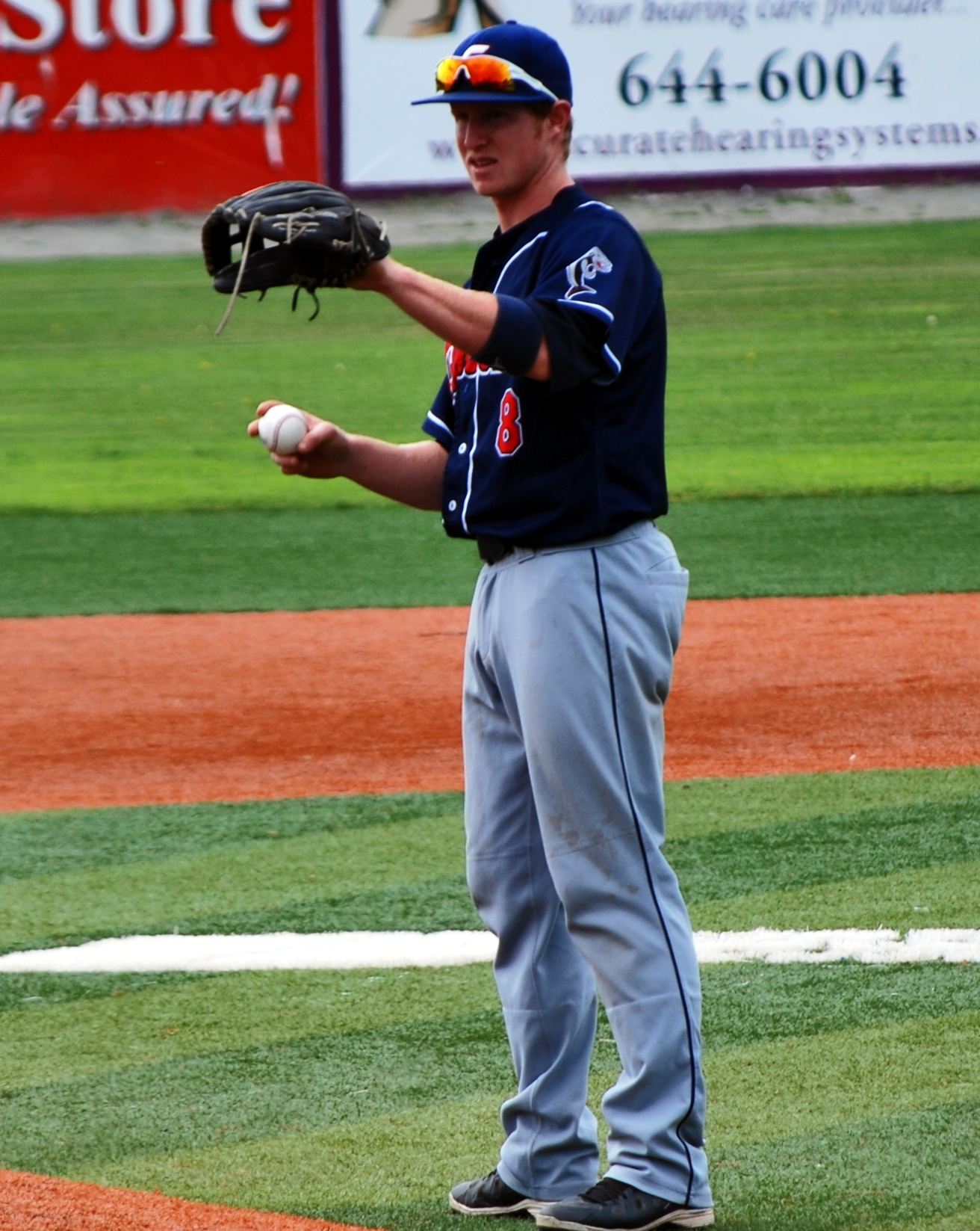 the man stands on the field with a ball in his hand