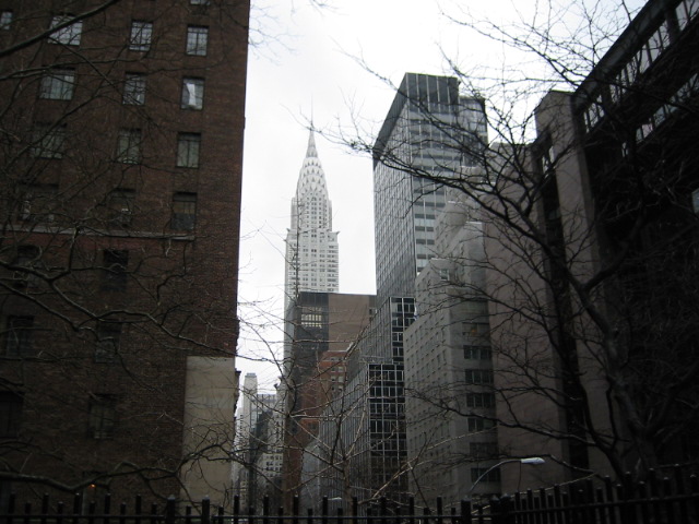 a street scene with tall buildings in the background