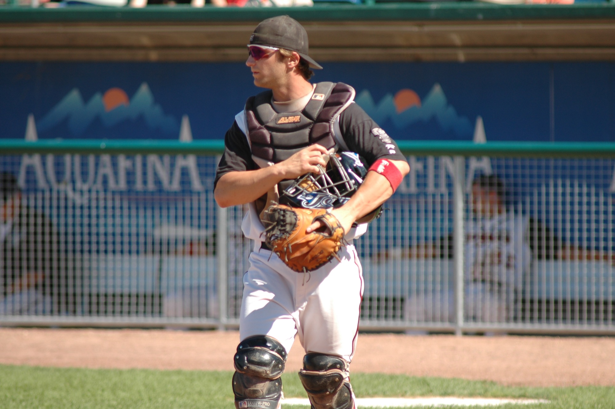 a baseball player holding his catchers mitt on the field