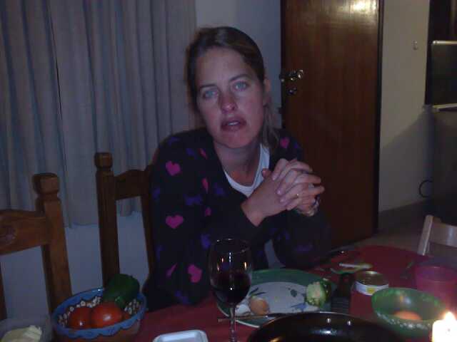 a woman sitting at a dining room table looking surprised