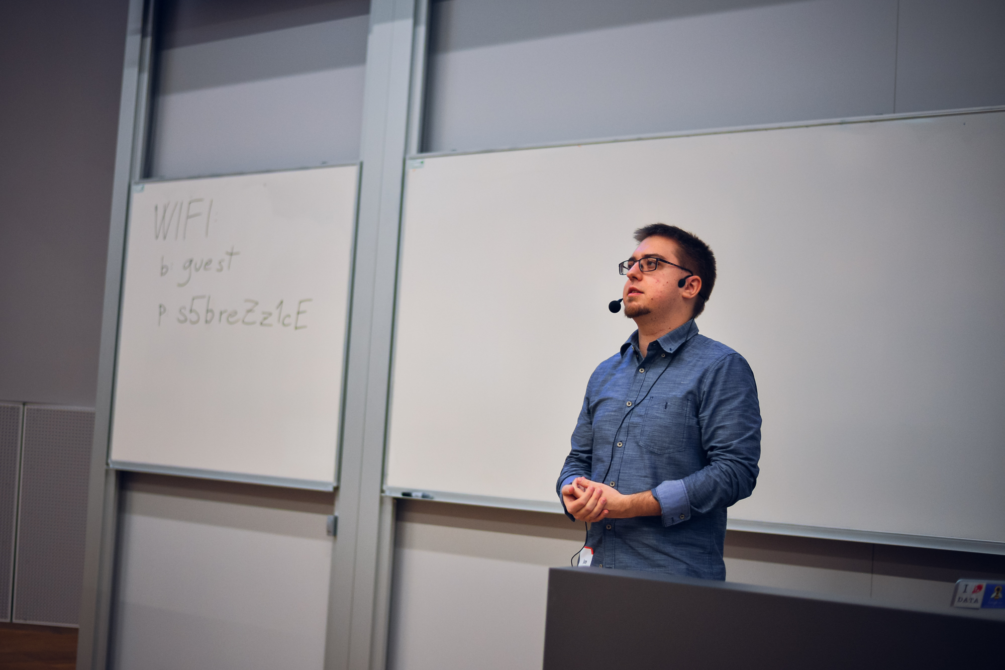 a man standing in front of a whiteboard giving a presentation