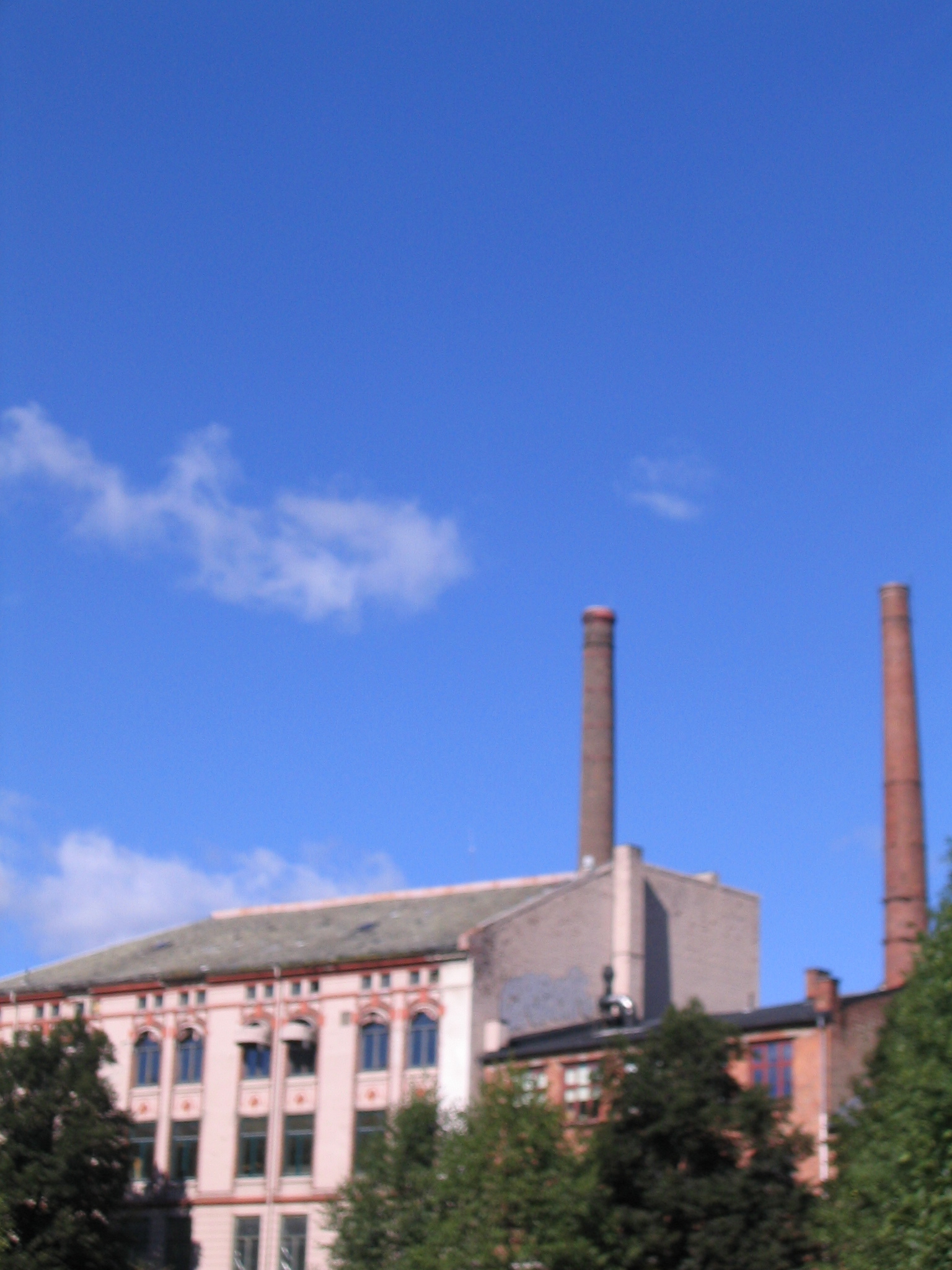 some smoke stacks are seen in the distance