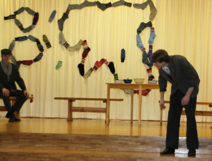 people standing in a room with wooden floors